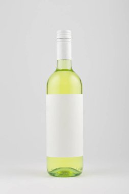 White wine bottle with blank white label on white background, mock up.
