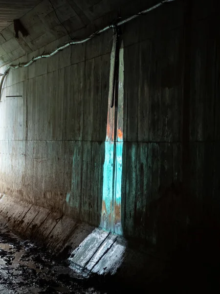 Tunnel Wall with a Water Seepage Reflecting a Blue Cloth