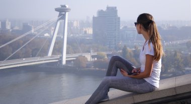 girl sitting over Bratislava clipart