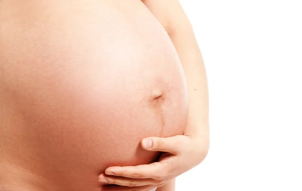 Beyaz arka plan üzerinde izole çıplak hamile karnına