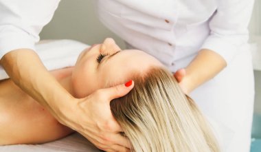 Güzellik uzmanı kozmetik uzmanı, müşteriler için bir güzellik salonunda kafa ve saç masajı uzmanı prosedürü uyguluyor. Spa sağlık ve kendine bakım kavramı.