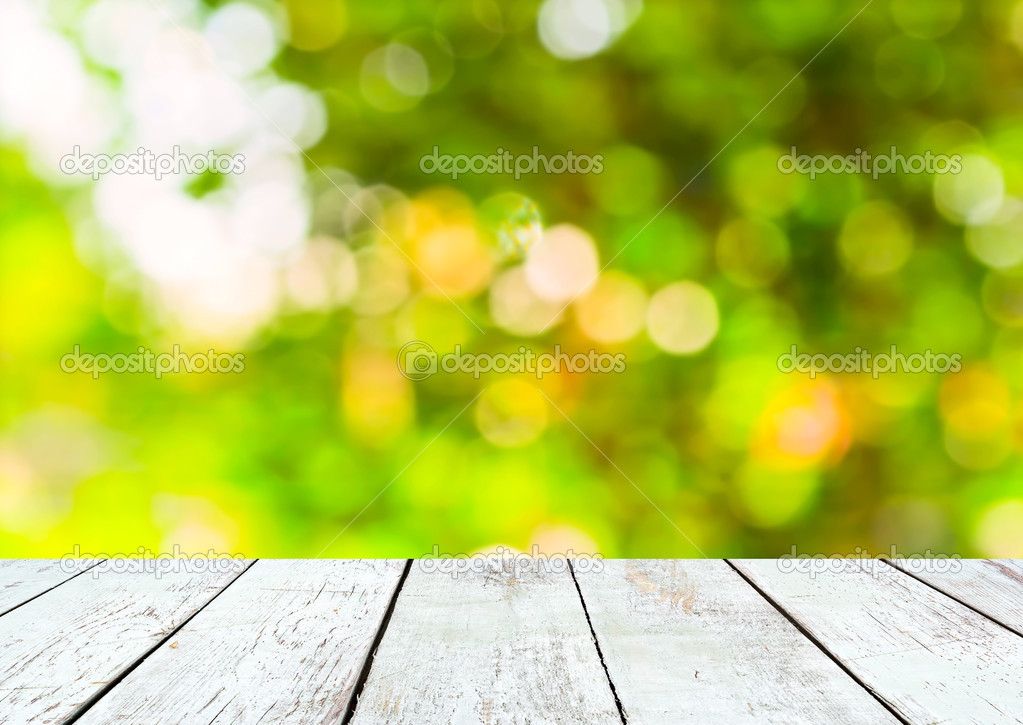 Empty wooden and green summer bokeh background
