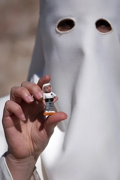 Penitent with a costalero figurine in his hand during Holy Week — Stock Photo, Image