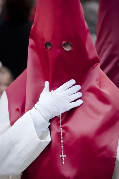 Penitent with a rosary in his hand in a procession — Stock Photo, Image