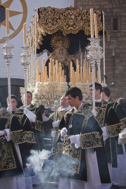 Young people in procession with incense burners and processional candlesticks in Holy week clipart