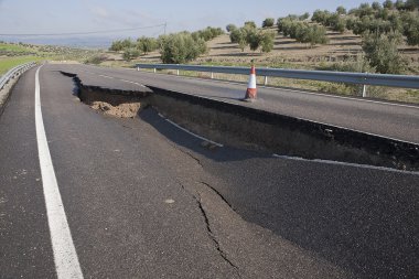 Asphalt road with a crack caused by landslides clipart