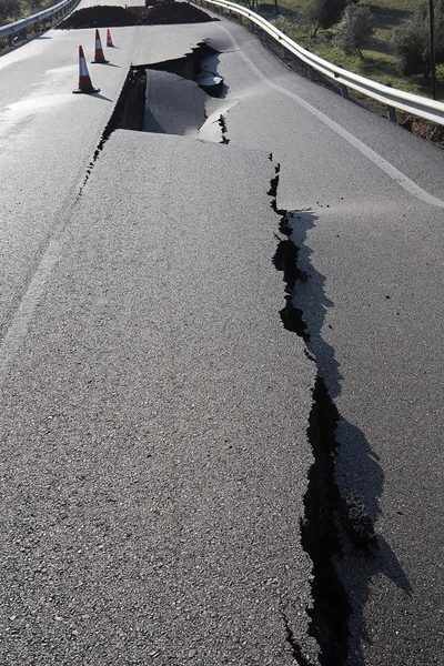 Asphalt road with a crack caused by landslides — Stock Photo, Image