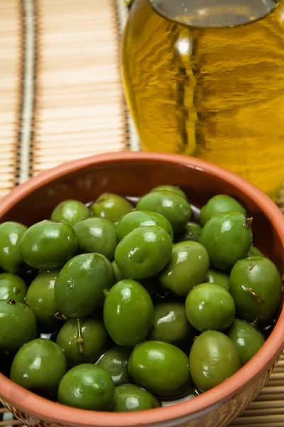 Bowl with green olives dressed — Stock Photo, Image