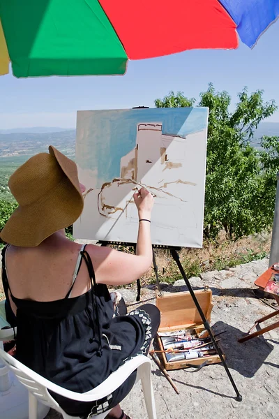 Woman painting on canvas near the castle of Sabiote — Stockfoto