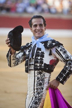 Bullfighter Ivan Fandiño to the turning of honour with montera hat in his hand in the Bullring of Baeza clipart