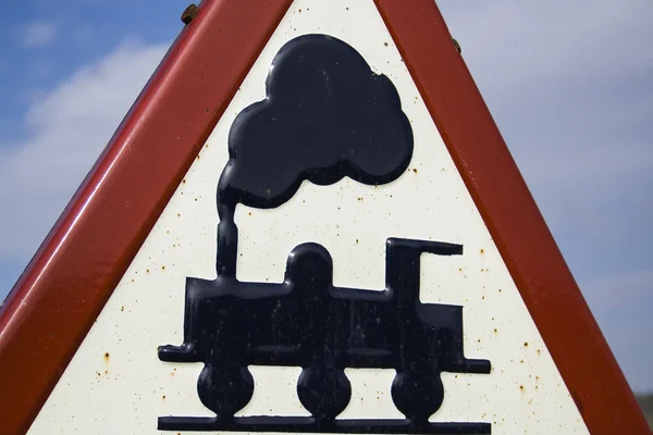 Warning sign worn of level crossing without barriers, blue sky with clouds — Stock Photo, Image