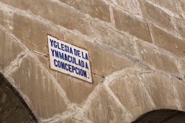 Detail architectural and sign of the street name written in old Castilian clipart