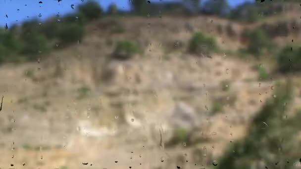 View of passing landscape from a train window after a rain intensively — Stock Video