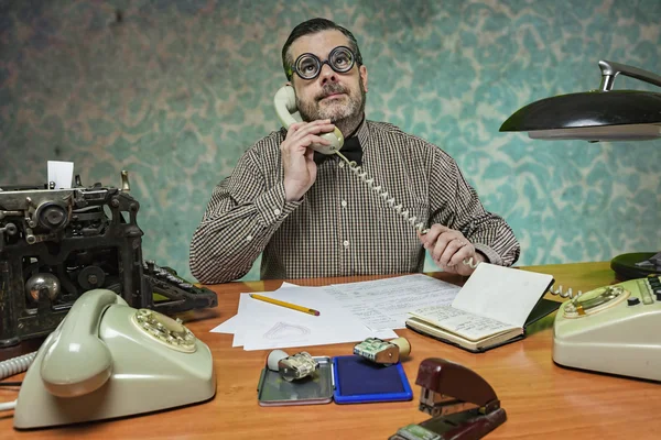 Employee with glasses talking on the phone in the office in the — Stock Photo, Image