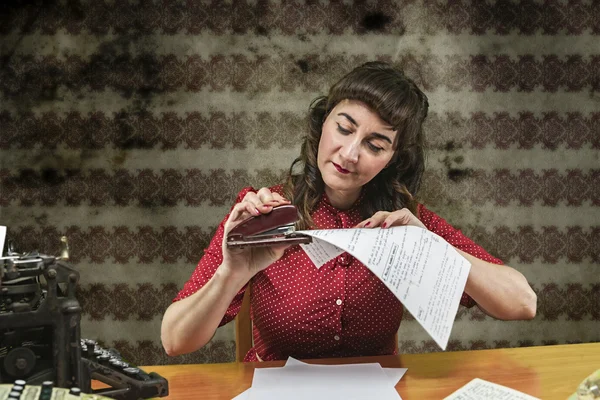 Young woman with red dress stapling papers in office, 1960's — Stock Photo, Image