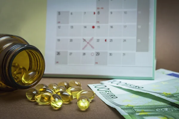 Control pills on a calendar — Stock Photo, Image