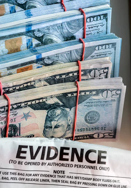 Evidence bag next to dollar banknotes in a crime investigation unit, concept image