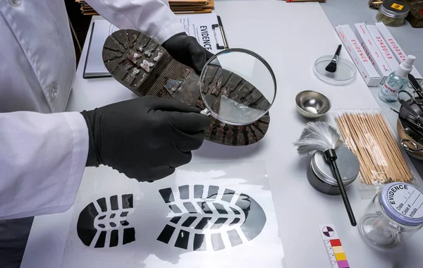 stock image Forensic scientist investigates shoeprint mould evidence in crime lab, conceptual image