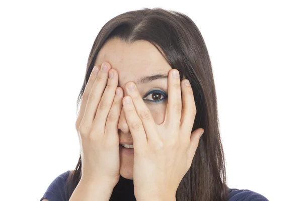 Woman peeking behind her hand — Stock Photo, Image