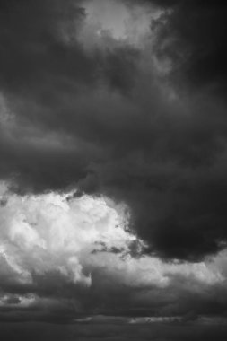 Epic Dramatic storm sky with dark grey black and white cumulus rainy clouds background texture. Black and white photo