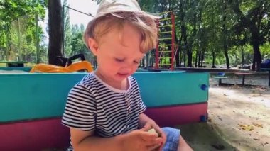 A small sick child uses a nasal aspirator into the nose, sucking out the mucus. Salty sea water helps to cure snot in a child. Copy space - concept of health, cold, immunity, prevention, cleansing