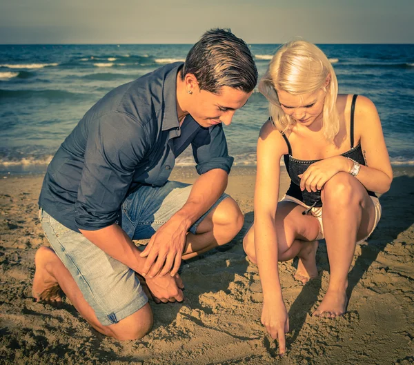 Hansome man och vacker kvinna att spendera tid på stranden — Stockfoto