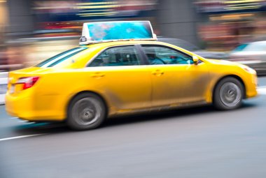 Yellow cab on the street clipart