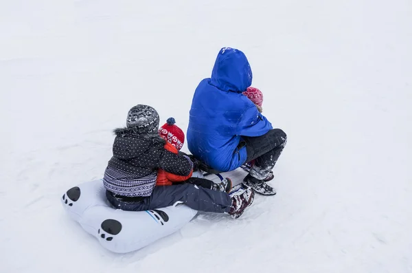 Family on the snow sled — Stock Photo, Image