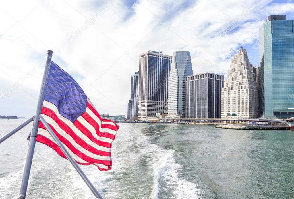 View of Manhattan skyline and flag of USA