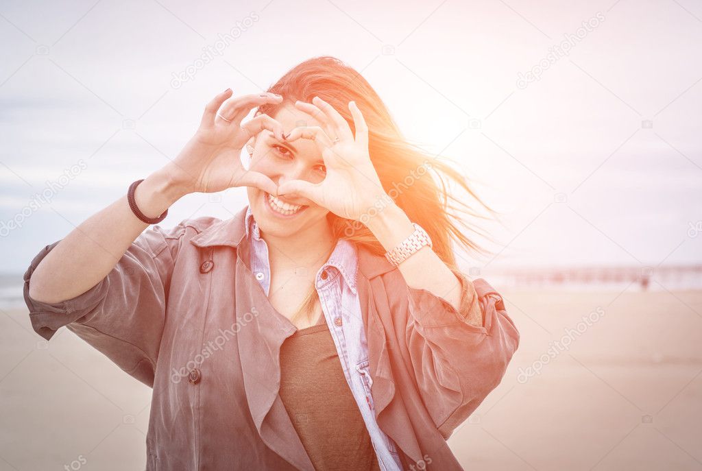 Woman makes heart symbol