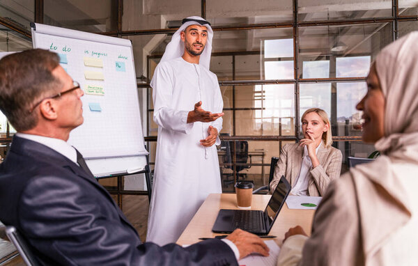 Multiethnic corporate business team meeting in the office for a strategic marketing plan - Office workers, entrepreneurs and company employee at work in a multinational company