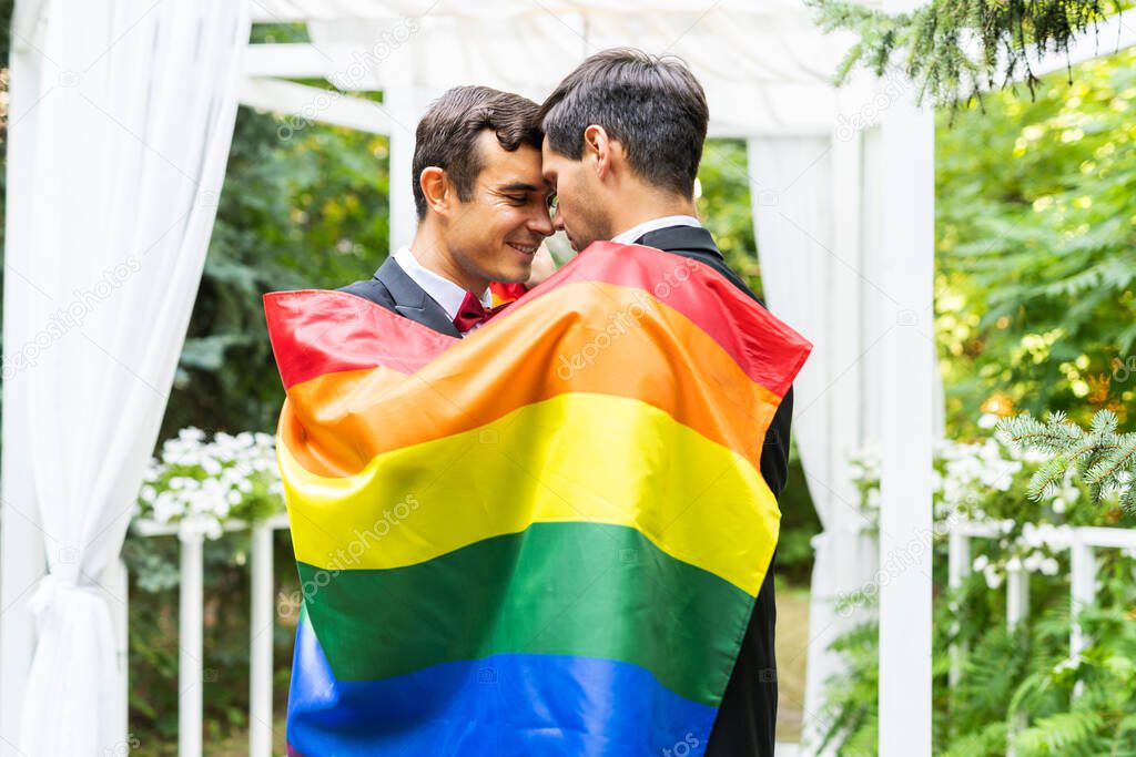 Homosexual couple celebrating their own wedding - LBGT couple at wedding ceremony, concepts about inclusiveness, LGBTQ community and social equity
