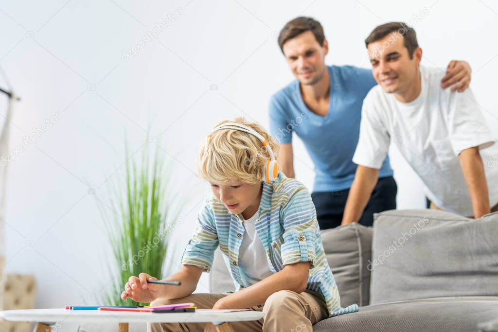 Lgbt family, gay couple with adopted son - Homosexual parents with their kid having fun at home