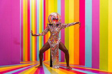 Beautiful african american young woman dancer having fun inside a rainbow box room - Cool and stylish afro adult woman portrait on multicolored background, influencer creating content for social networks in a selfie room clipart