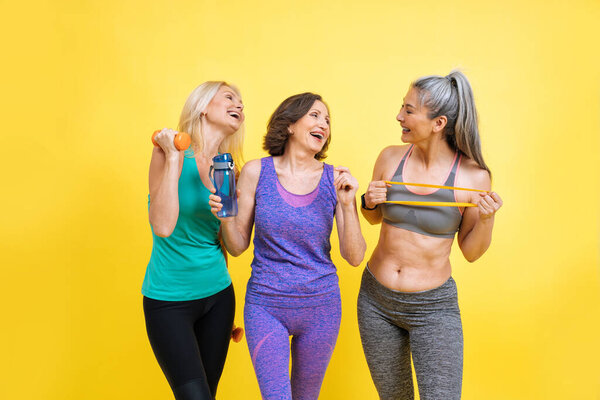 group of women with different body, age, and ethnicity making sport. Female models wearing sport outfits having fun at the gym. Concept about body positivity, self acceptance and lifestyle