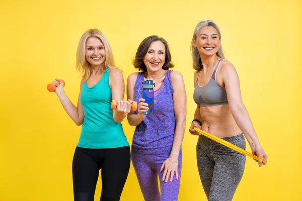 group of women with different body, age, and ethnicity making sport. Female models wearing sport outfits having fun at the gym. Concept about body positivity, self acceptance and lifestyle