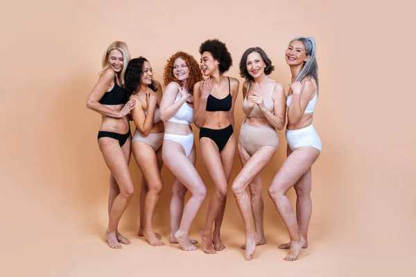 Free Photo  Group of attractive young women in underwear sitting in studio