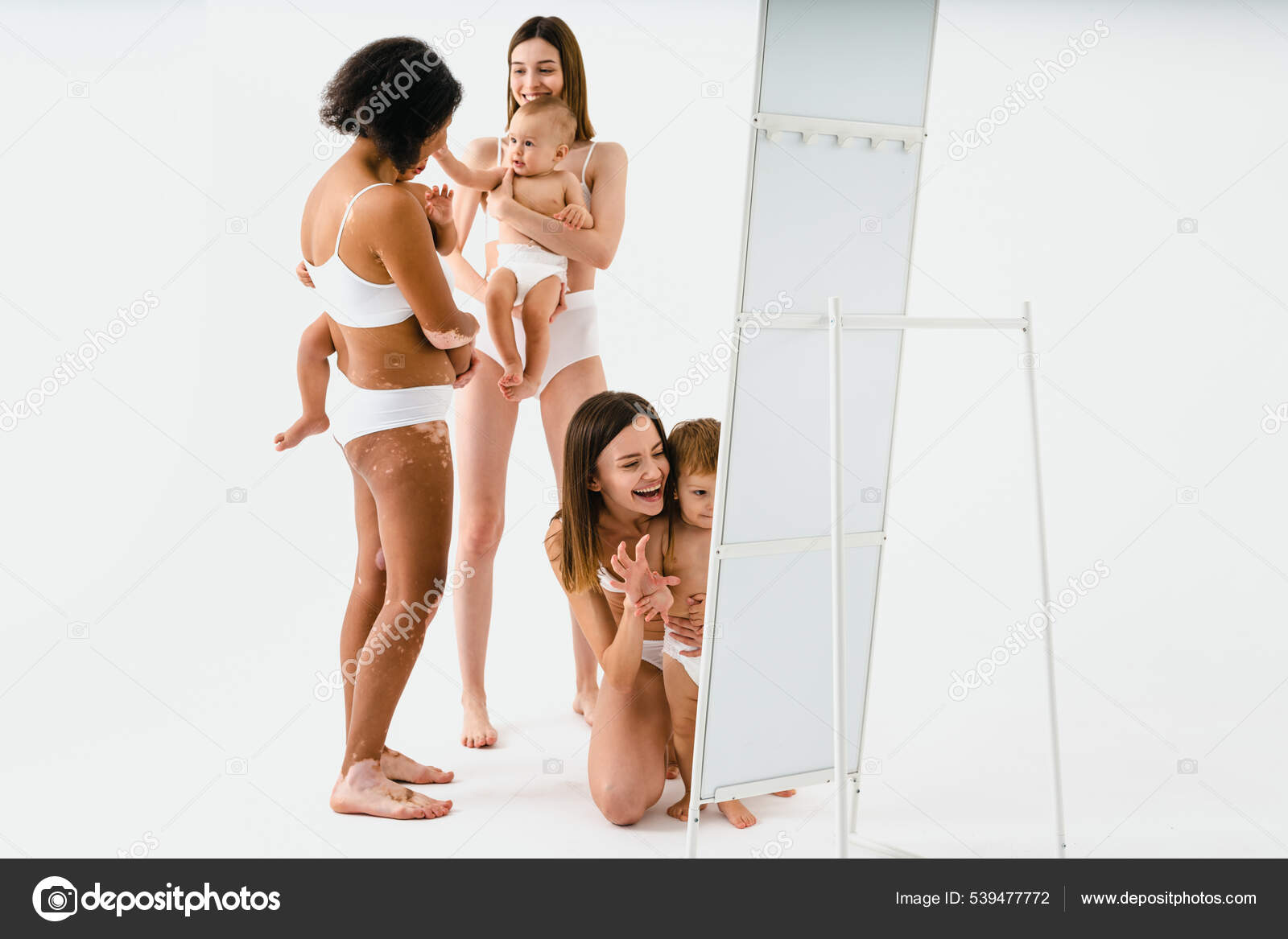 Happy Multiethnic Women Holding Babies Colored Background Young Women  Wearing Stock Photo by ©oneinchpunch 539477772