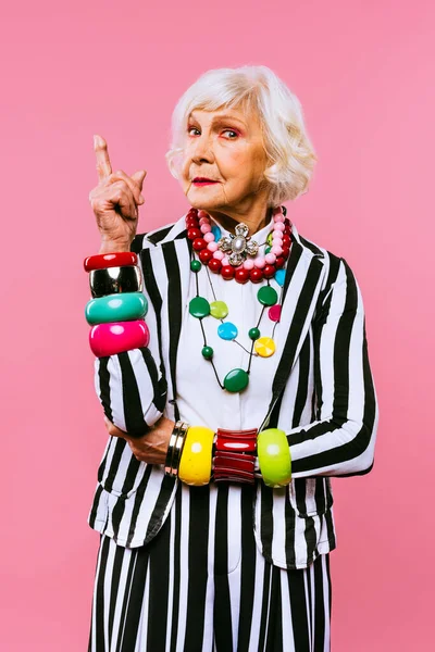 Happy and funny cool old lady with fashionable clothes portrait on colored background - Youthful grandmother with extravagant style, concepts about lifestyle, seniority and elderly people