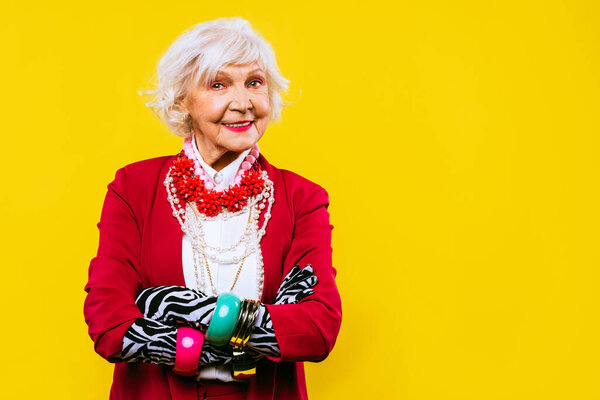 Happy and funny cool old lady with fashionable clothes portrait on colored background - Youthful grandmother with extravagant style, concepts about lifestyle, seniority and elderly people