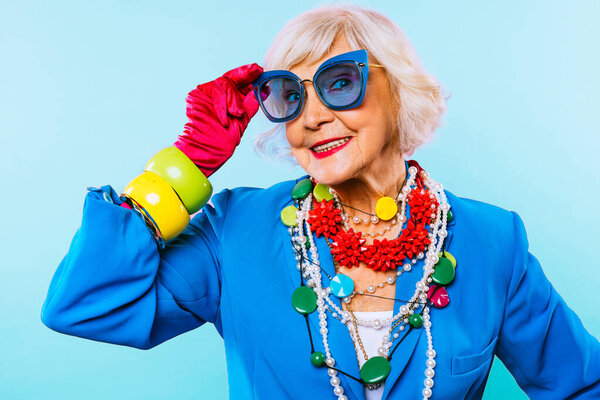 Happy and funny cool old lady with fashionable clothes portrait on colored background - Youthful grandmother with extravagant style, concepts about lifestyle, seniority and elderly people