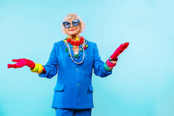 Happy and funny cool old lady with fashionable clothes portrait on colored background - Youthful grandmother with extravagant style, concepts about lifestyle, seniority and elderly people