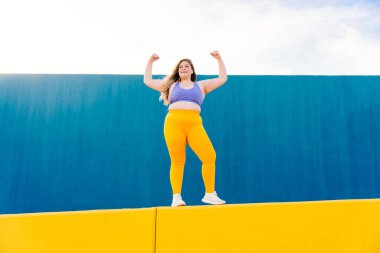 Beautiful and cheerful plus size young woman outdoors - Pretty overweight curvy female, concepts about femininity, women power, female emancipation, body positivity and body acceptance