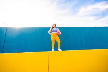 Beautiful and cheerful plus size young woman outdoors - Pretty overweight curvy female, concepts about femininity, women power, female emancipation, body positivity and body acceptance