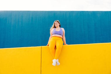 Beautiful and cheerful plus size young woman outdoors - Pretty overweight curvy female, concepts about femininity, women power, female emancipation, body positivity and body acceptance