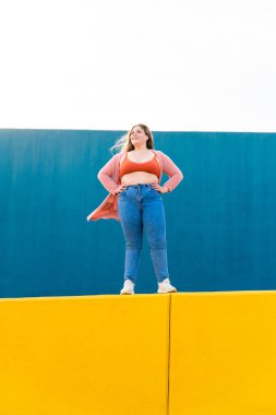 Beautiful and cheerful plus size young woman outdoors - Pretty overweight curvy female, concepts about femininity, women power, female emancipation, body positivity and body acceptance