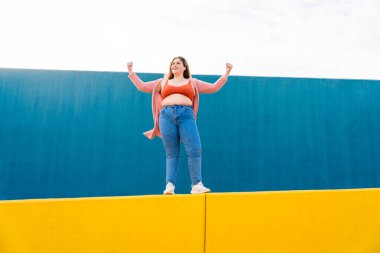 Beautiful and cheerful plus size young woman outdoors - Pretty overweight curvy female, concepts about femininity, women power, female emancipation, body positivity and body acceptance