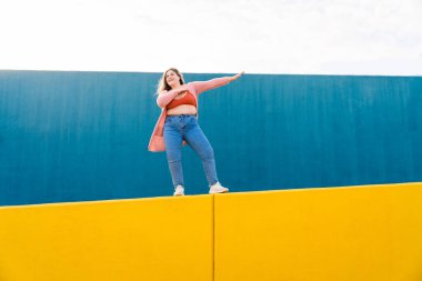 Beautiful and cheerful plus size young woman outdoors - Pretty overweight curvy female, concepts about femininity, women power, female emancipation, body positivity and body acceptance