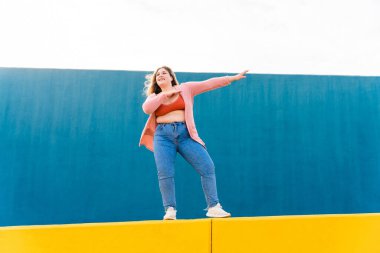 Beautiful and cheerful plus size young woman outdoors - Pretty overweight curvy female, concepts about femininity, women power, female emancipation, body positivity and body acceptance