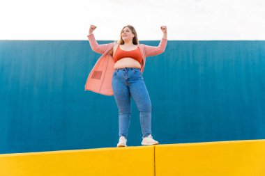 Beautiful and cheerful plus size young woman outdoors - Pretty overweight curvy female, concepts about femininity, women power, female emancipation, body positivity and body acceptance